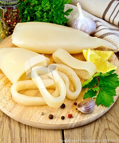 Image of Calamari with lemon and parsley on board