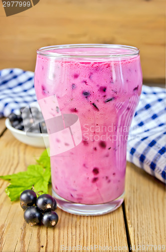 Image of Milkshake with black currants and napkin on board