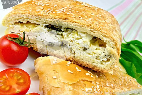 Image of Roll filled with spinach and cheese on linen tablecloth