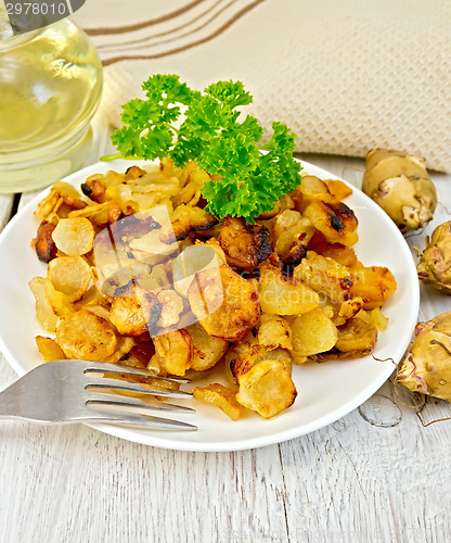 Image of Jerusalem artichokes fried with parsley on plate