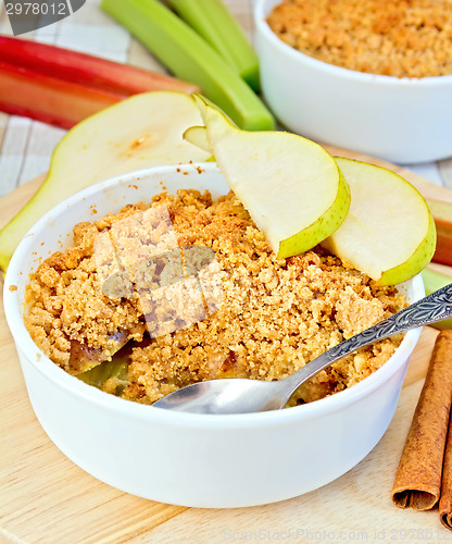 Image of Crumble with pears and rhubarb on linen tablecloth