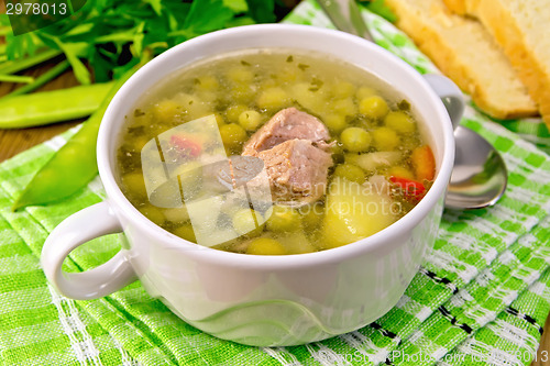 Image of Soup from green peas with meat on green napkin