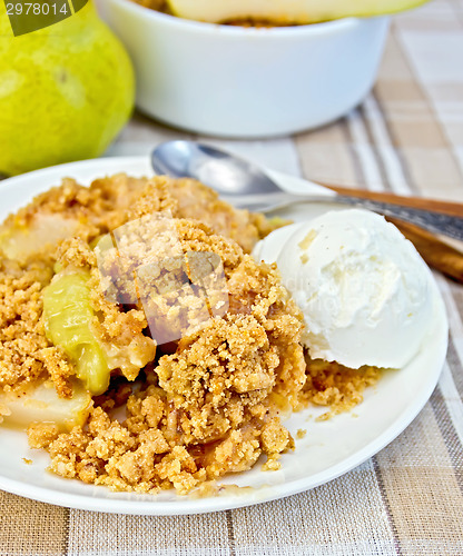 Image of Crumble with pears in bowl on linen tablecloth