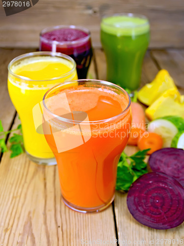 Image of Juice vegetable in four glasses on wooden board