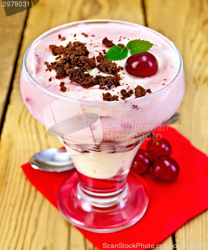 Image of Dessert milk with cherry and biscuit on paper napkin