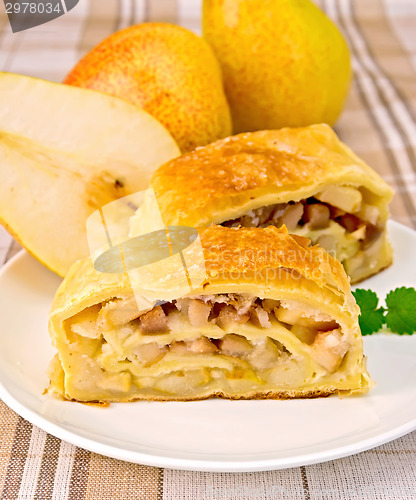 Image of Strudel with pears on linen tablecloth
