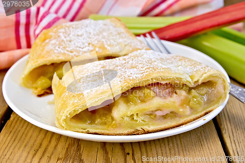 Image of Strudel with rhubarb and fork in plate on board