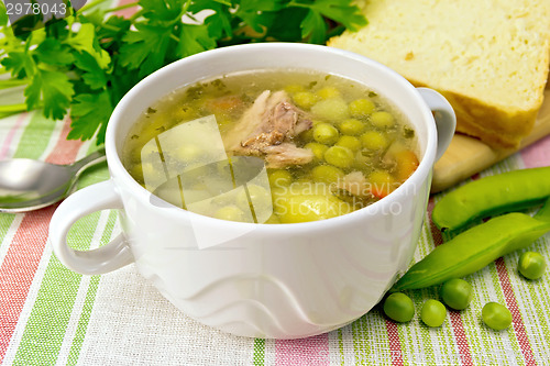 Image of Soup from green peas with meat on napkin