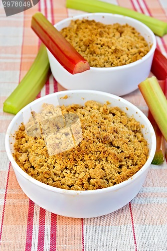 Image of Crumble with rhubarb in two bowls on linen tablecloth