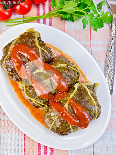 Image of Rhubarb leaves stuffed in bowl with sauce