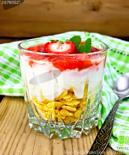 Image of Dessert milk with strawberry and flakes in glass on board