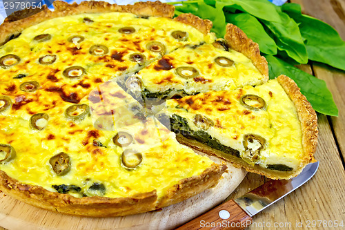 Image of Pie with spinach and olives on board