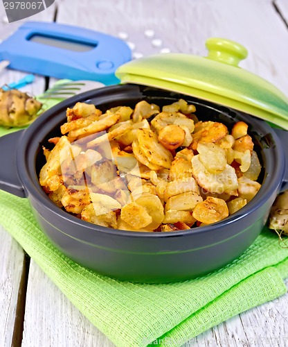 Image of Jerusalem artichokes roasted in pan with meter on light board