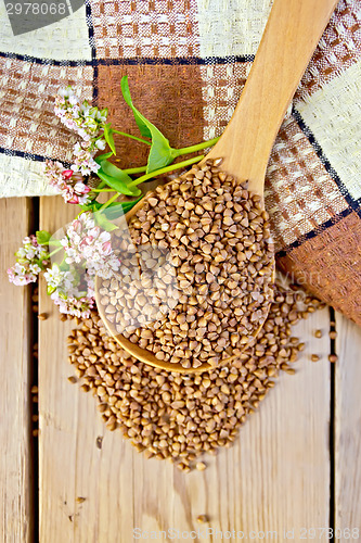 Image of Buckwheat in spoon and napkin with flower on board