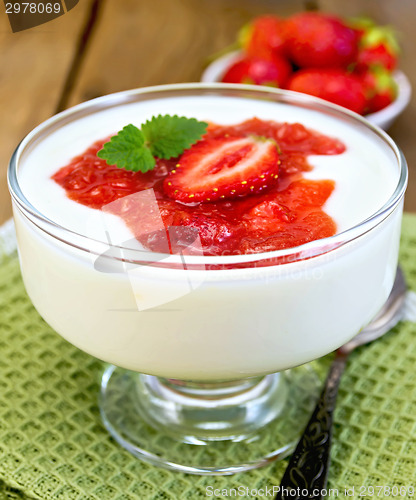 Image of Dessert milk with strawberry in goblet on napkin