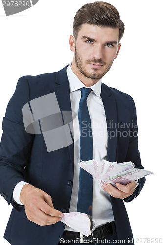 Image of Wealthy successful businessman burning money