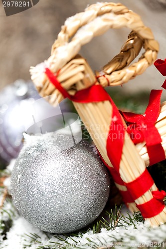 Image of Silver Christmas bauble on a tree with snow