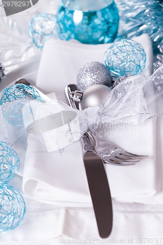 Image of Stylish blue and silver Christmas table setting