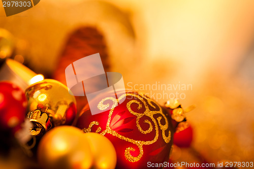 Image of Warm gold and red Christmas candlelight background