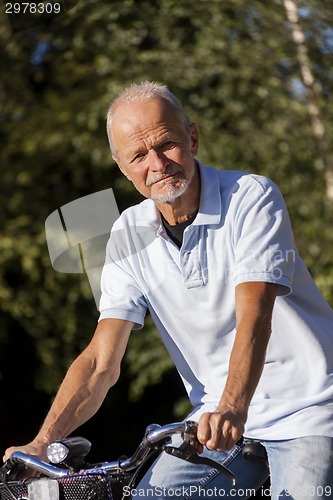 Image of Senior Man Riding Bicycle