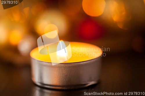 Image of Warm gold and red Christmas candlelight background