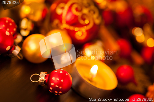 Image of Warm gold and red Christmas candlelight background