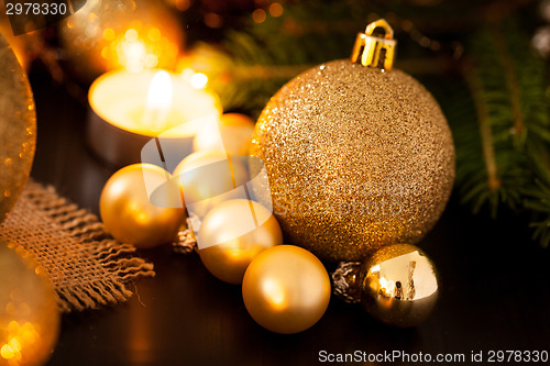 Image of Warm gold and red Christmas candlelight background