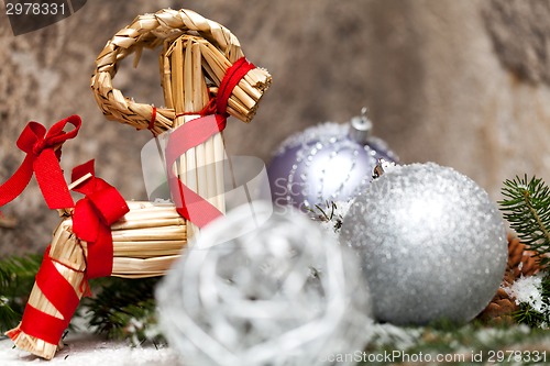 Image of Silver Christmas bauble on a tree with snow