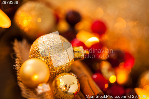 Image of Warm gold and red Christmas candlelight background