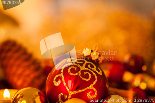 Image of Warm gold and red Christmas candlelight background