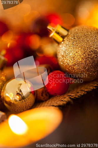 Image of Warm gold and red Christmas candlelight background