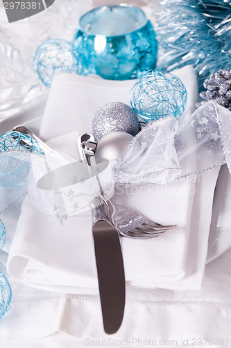 Image of Stylish blue and silver Christmas table setting