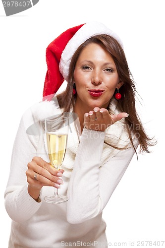 Image of Playful woman celebrating Xmas blowing a kiss