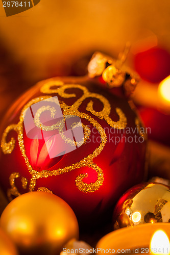 Image of Warm gold and red Christmas candlelight background