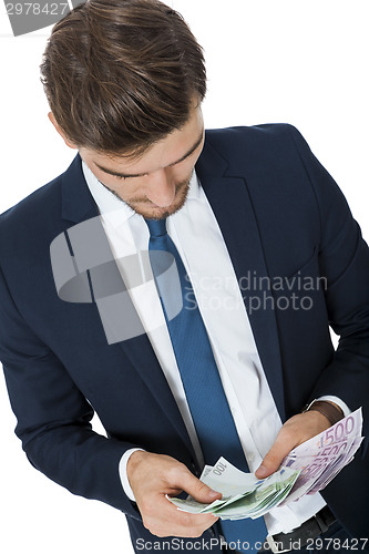 Image of Wealthy successful businessman burning money