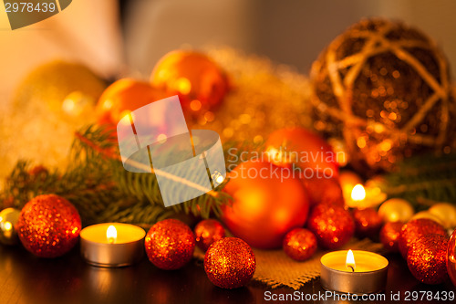 Image of Warm gold and red Christmas candlelight background