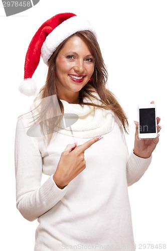 Image of Pretty woman in a Santa hat reading an sms