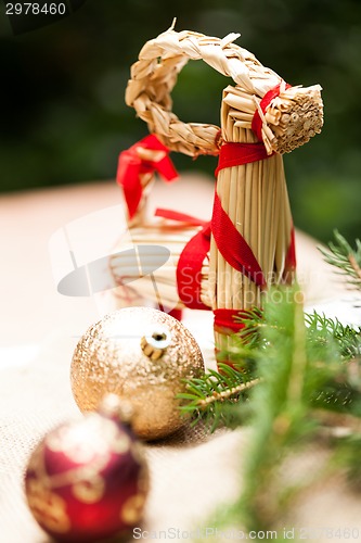 Image of Gold Christmas ornament on leaves