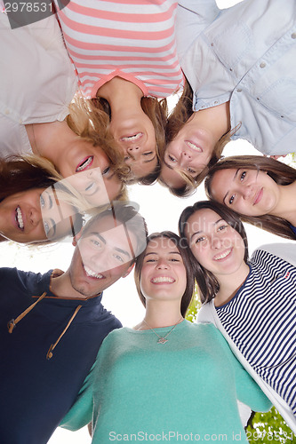 Image of young friends staying together outdoor in the park