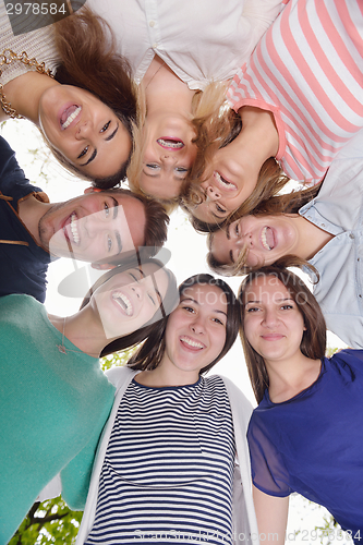 Image of young friends staying together outdoor in the park