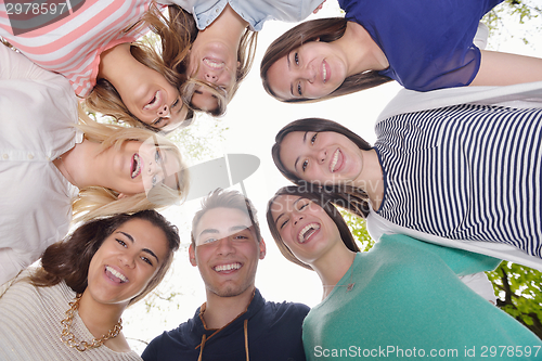 Image of young friends staying together outdoor in the park