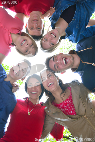 Image of young friends staying together outdoor in the park