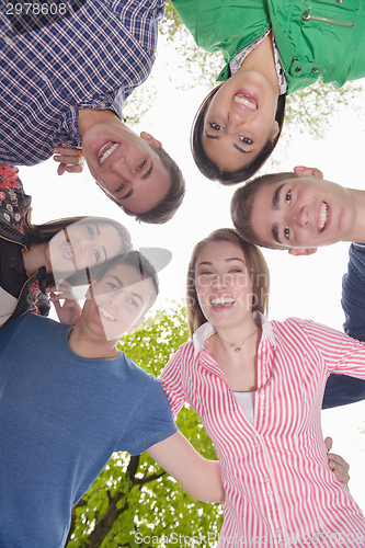 Image of young friends staying together outdoor in the park