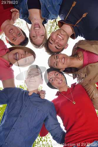 Image of young friends staying together outdoor in the park