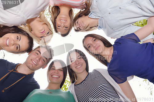 Image of young friends staying together outdoor in the park