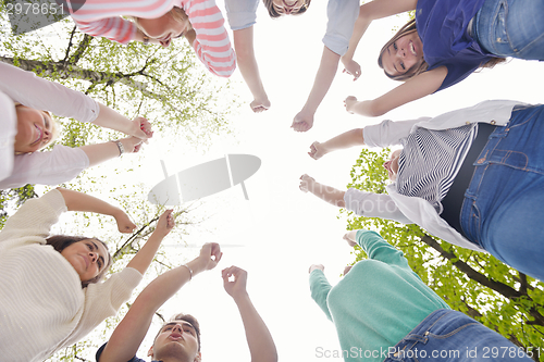 Image of young friends staying together outdoor in the park