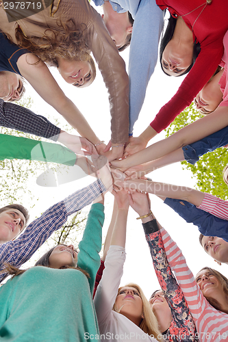 Image of young friends staying together outdoor in the park