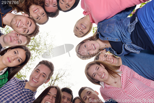 Image of young friends staying together outdoor in the park