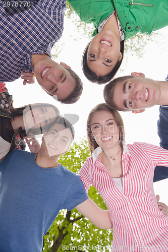 Image of young friends staying together outdoor in the park