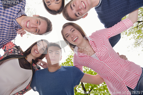 Image of young friends staying together outdoor in the park